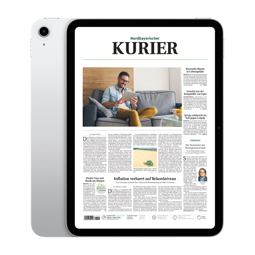 Tablet displaying the Nordbayerischer Kurier front page with a man reading on a couch tablet in his living room